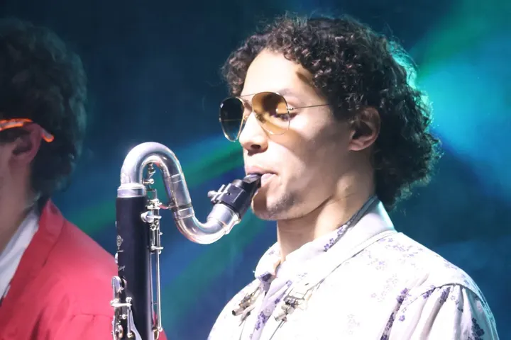 Bass clarinet under green and blue stage lights